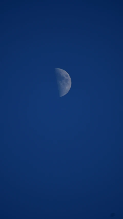 a half moon in the night sky with no clouds