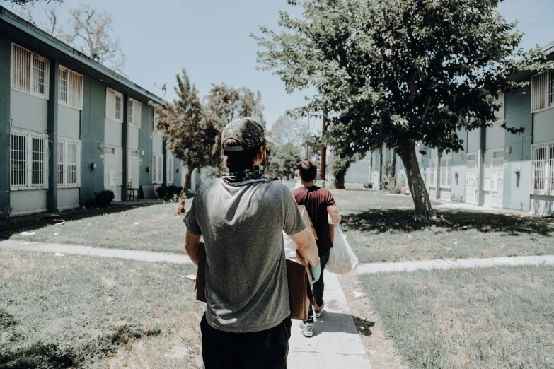 several men are walking down the side walk