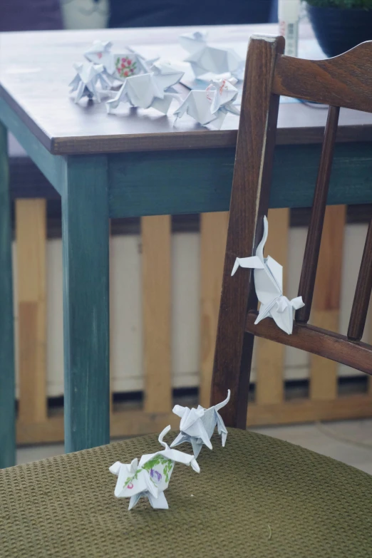 the paper flowers are sitting on the wooden table