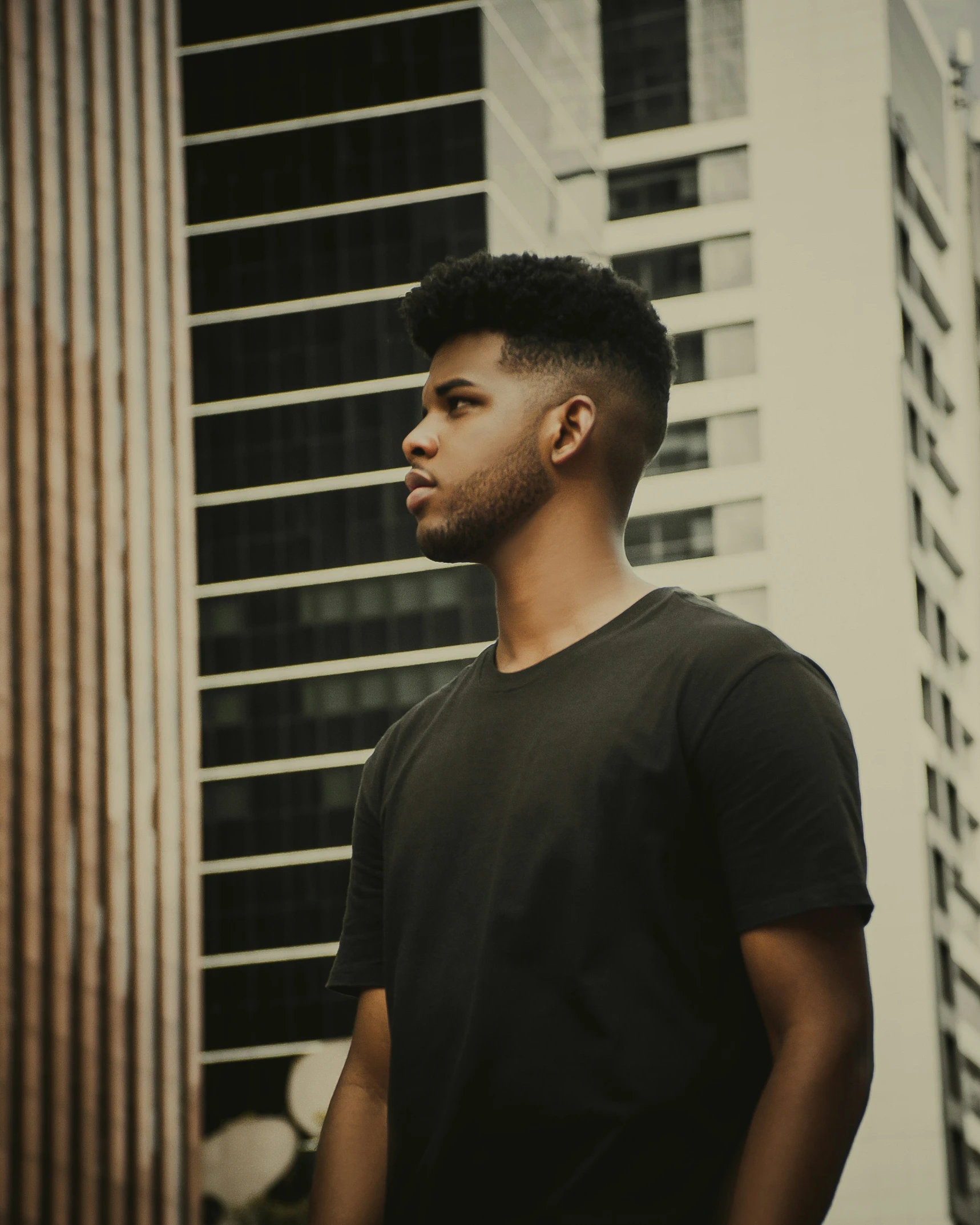 a man standing in front of a tall building