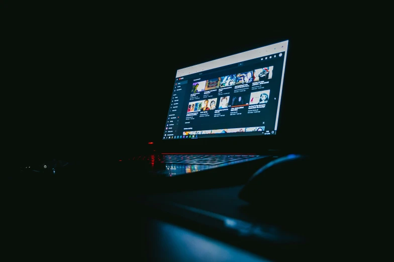 a person using a laptop on a dark surface