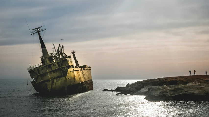 a large dirty ship sitting in the middle of a body of water