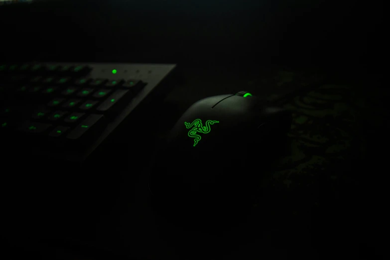 a close up of a keyboard with a green glowing mouse