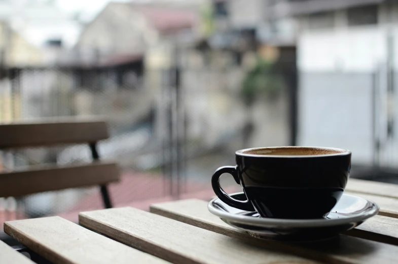 a cup is on the table by the balcony