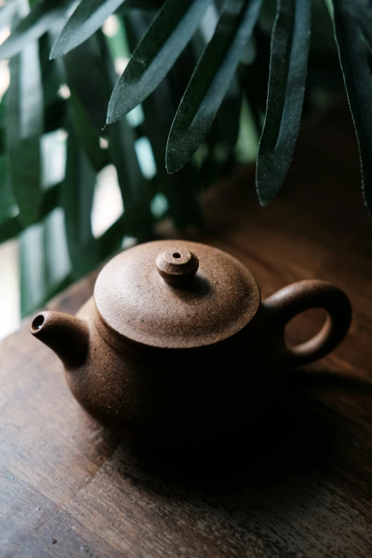 a wooden teapot sitting on top of a table