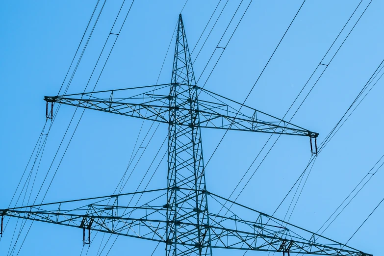 the view from below of a tower with many lines above