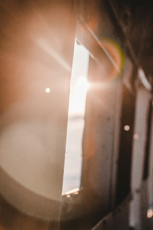 sunlight shines down on the wall and floor behind a door