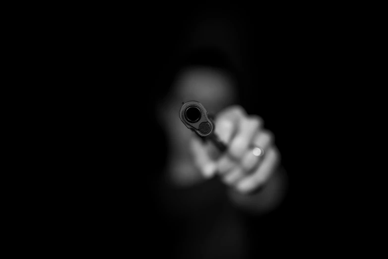 a person holding a gun in the dark