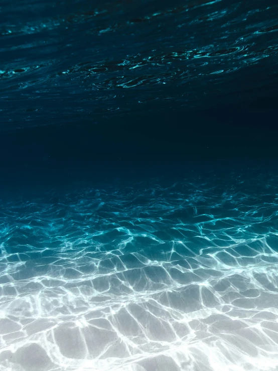 the view from under the water surface of a large open ocean