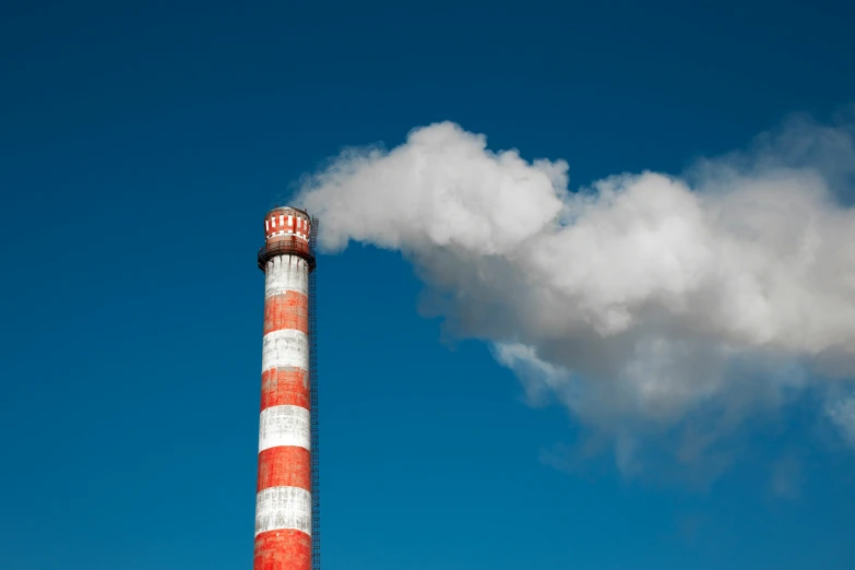 smoke billows from the top of a factory