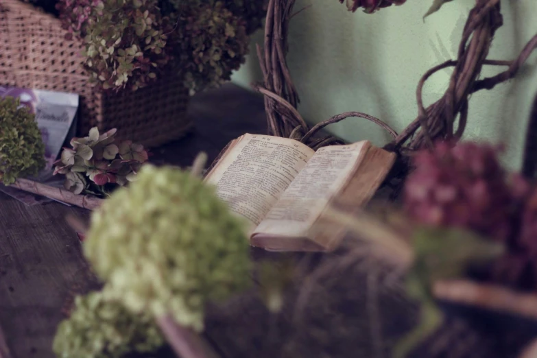 a books is sitting on the table with flowers