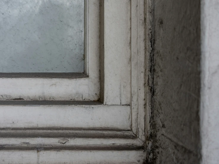 an image of an old looking window and dirty windowsill