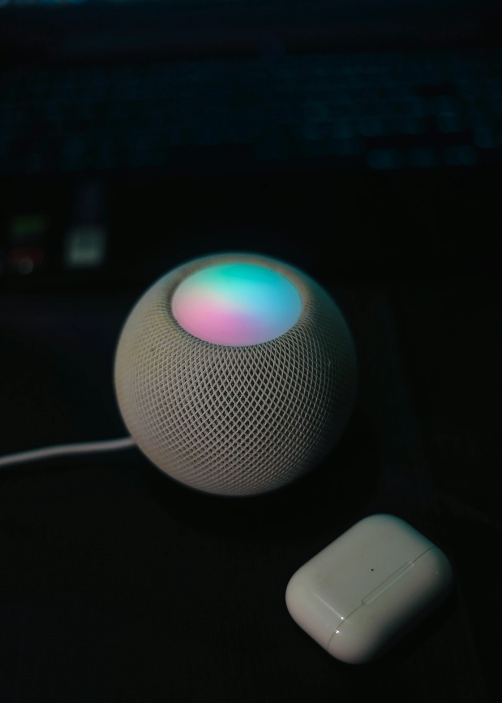 an apple home on is positioned on the surface of a computer keyboard