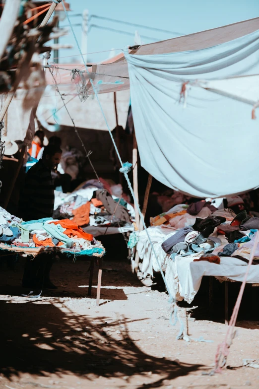 a bed on the ground under a tent