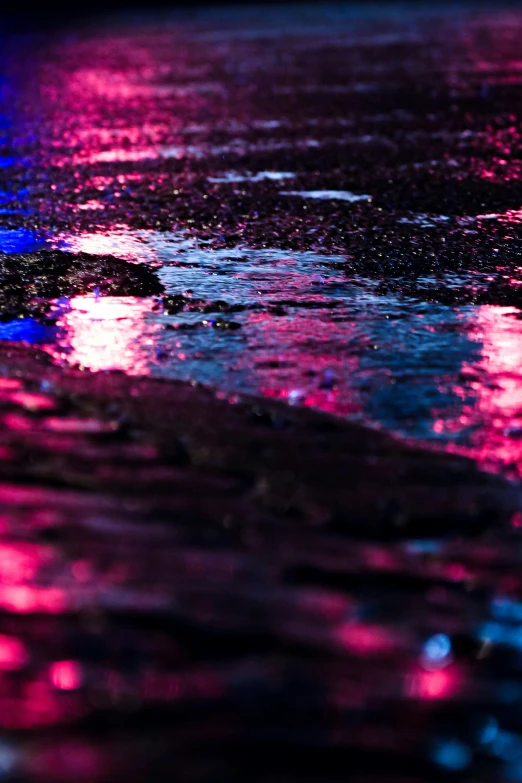 the wet road is colorful in the distance