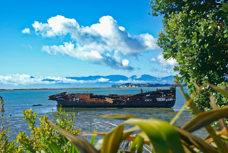 an old boat docked off the shore