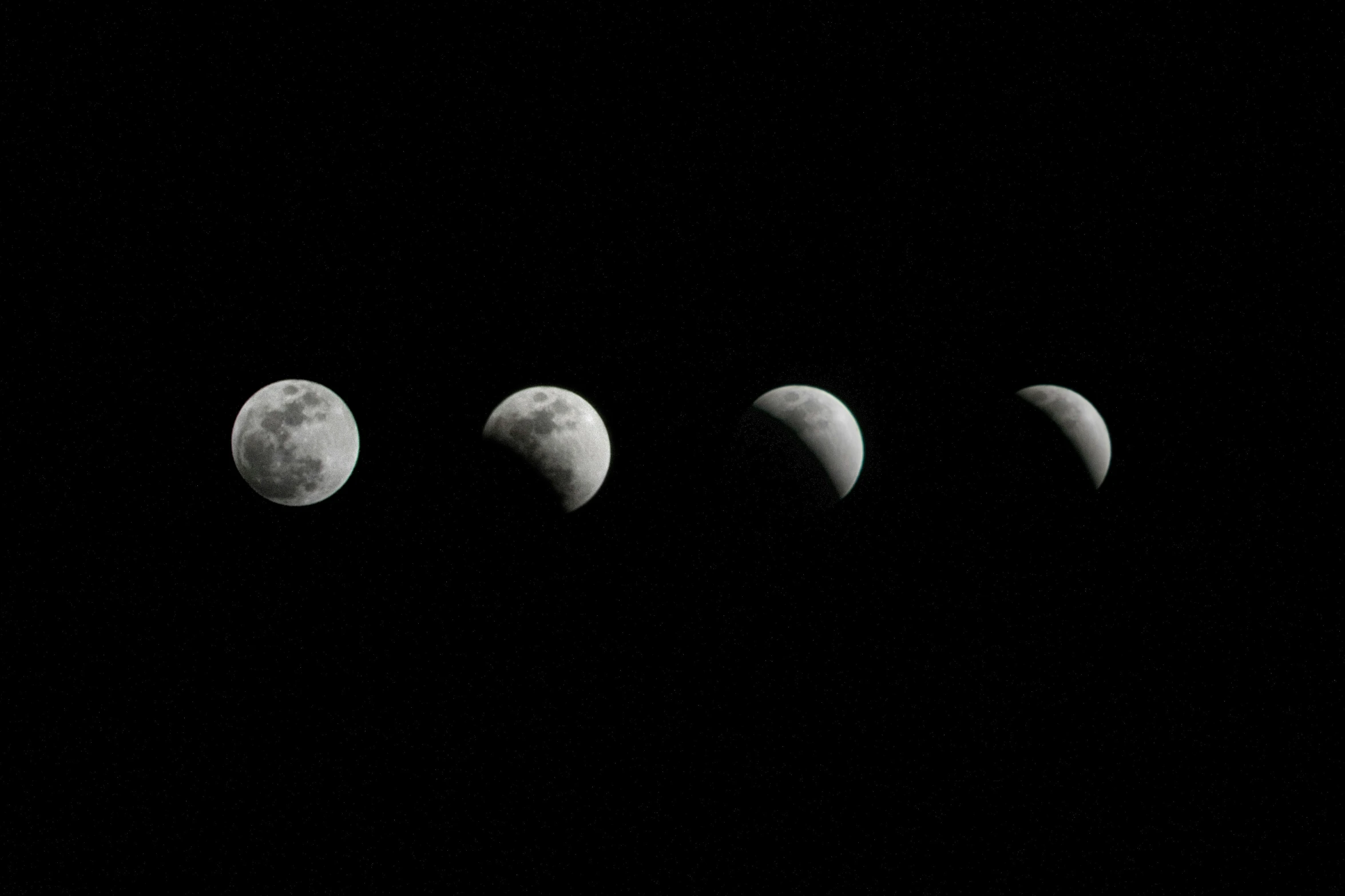 a black background of five phases of the moon