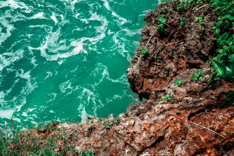 water and rocks in front of a rocky wall