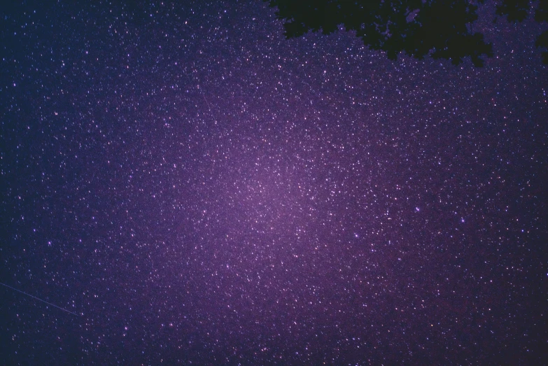 a purple sky with some stars all over