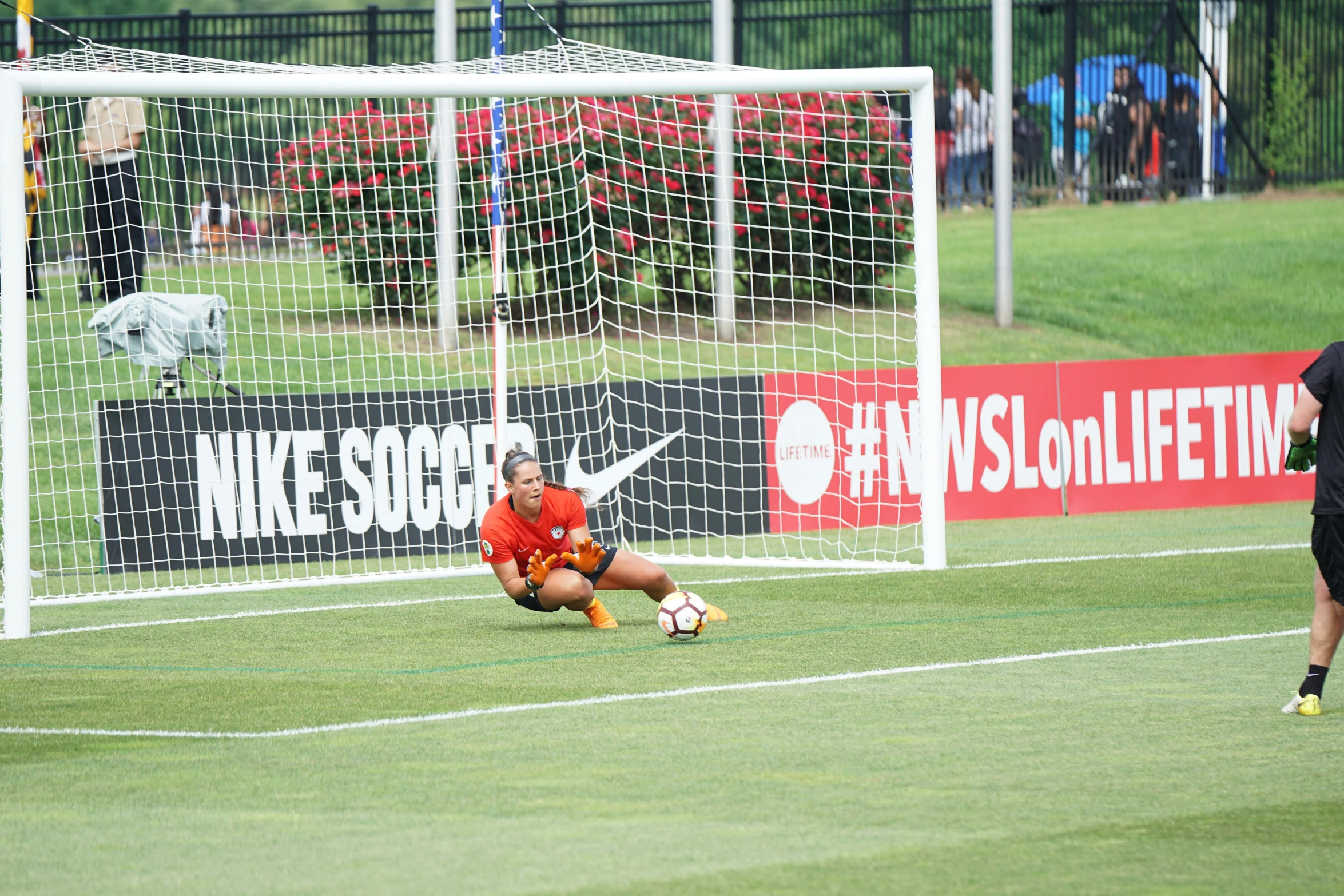 a soccer player looking at her knees on the field