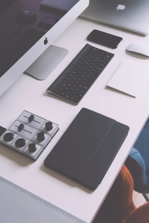 different electronic devices sitting on a white surface