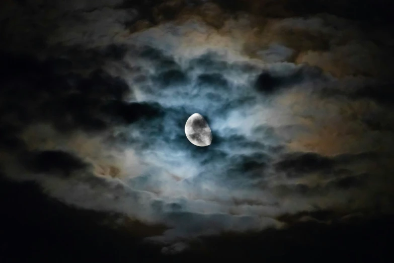 the moon appears to have just been framed by clouds