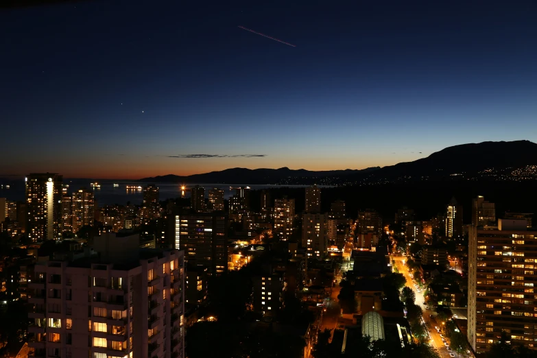 a large city with tall buildings under a blue night sky