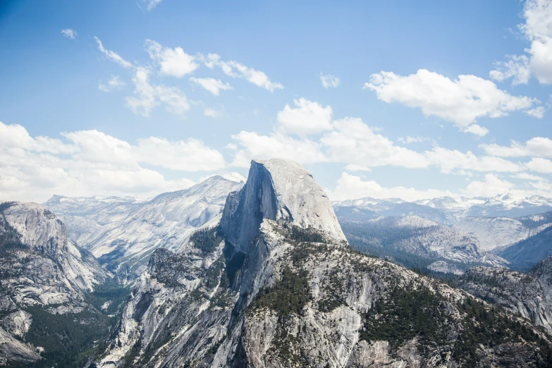 a large mountain with a small patch of white clouds