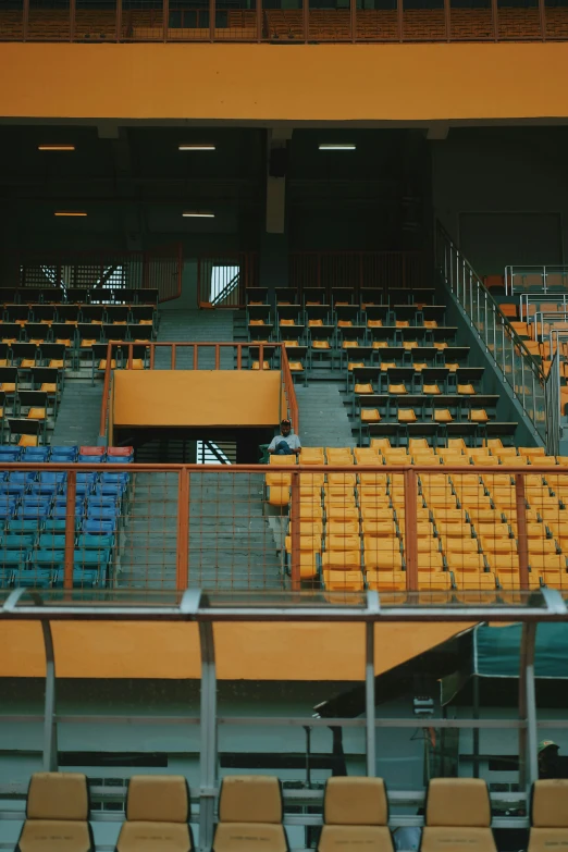 empty stadium seats sitting on a staircase at the top of a tall building