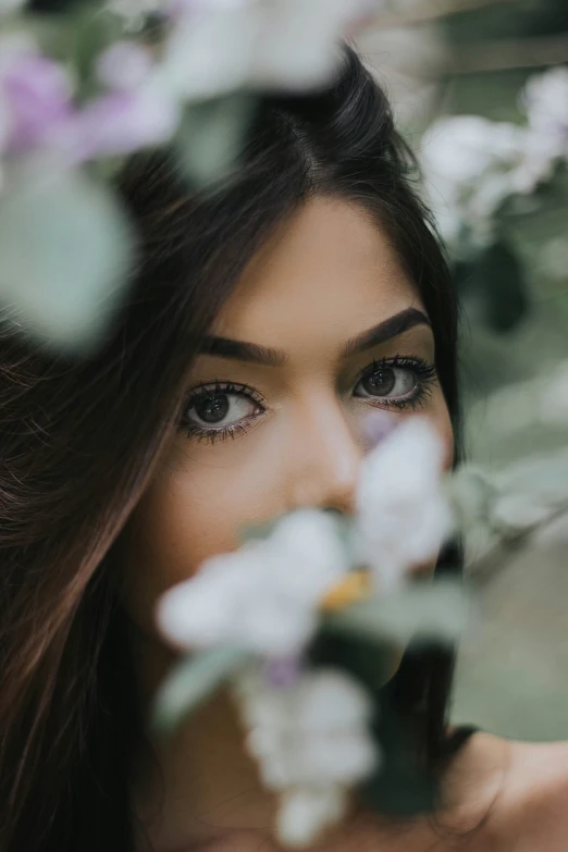 the woman is posing in front of flowers