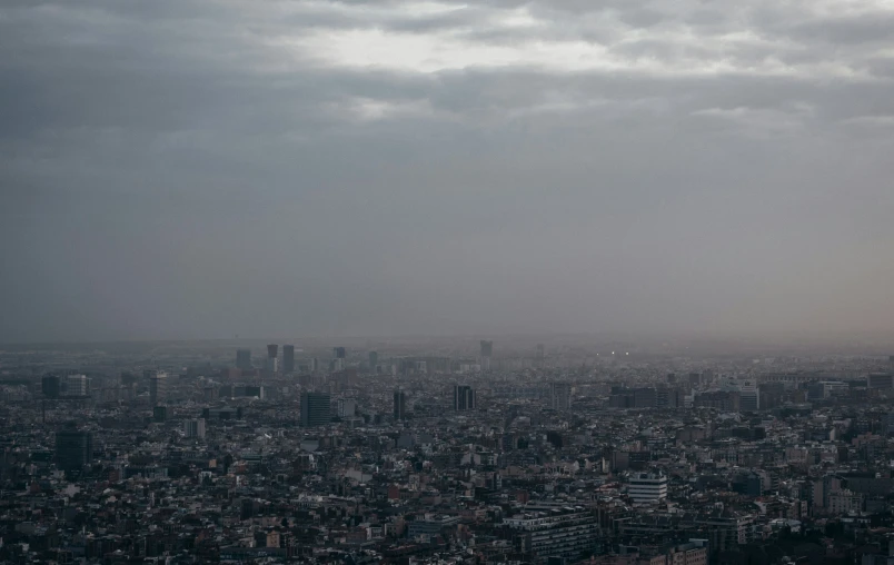 an urban area is shown under a dark cloud