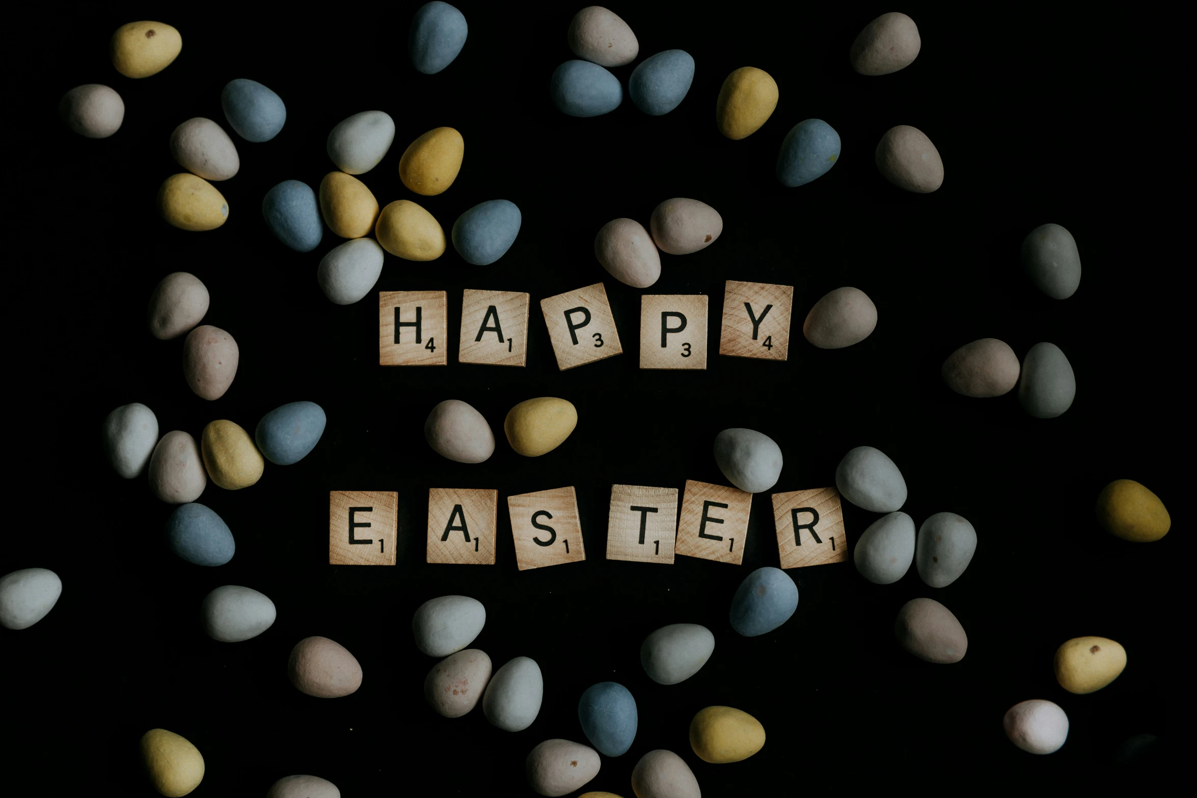 letters that spell out happy easter surrounded by pees