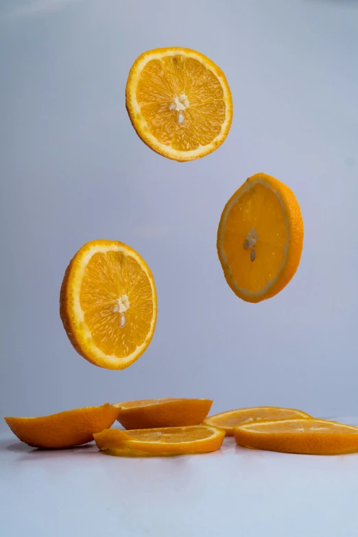 several oranges are flying through the air