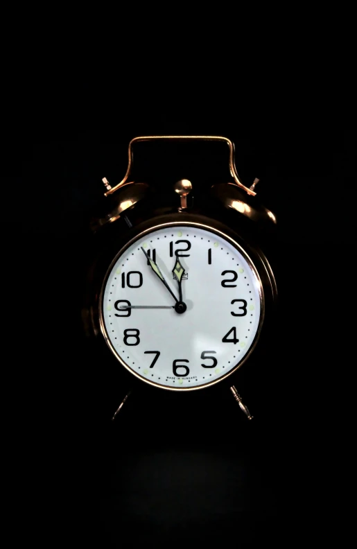 a clock in the dark lit up by a light