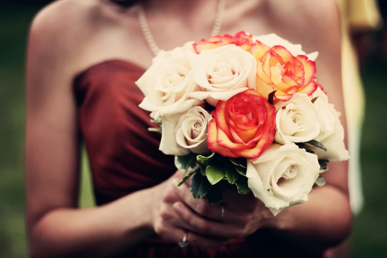 a woman in a red dress holding a flower bouquet