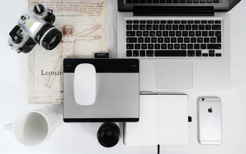 several electronics are sitting on the desk top