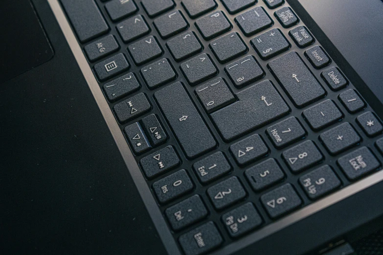 a black computer keyboard sitting on top of a desk