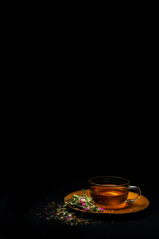 a cup of tea with a leafy sprig on top