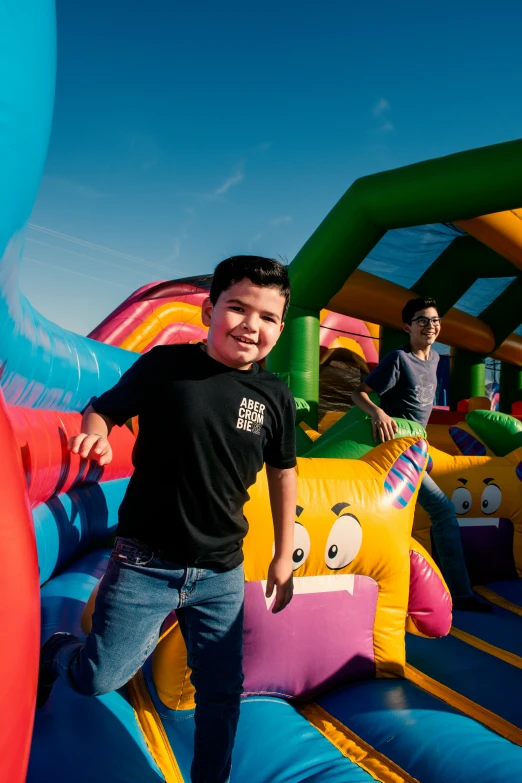 a little boy standing in an inflatable bouncy