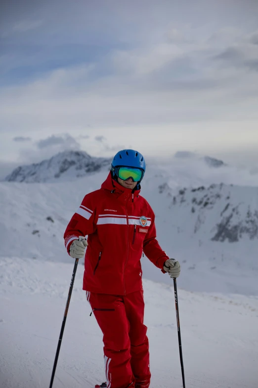 a man in red ski suit on a slope