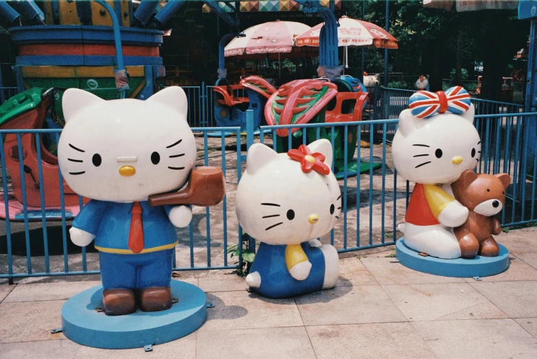 the large statues are depicting hello kitty and her cubs