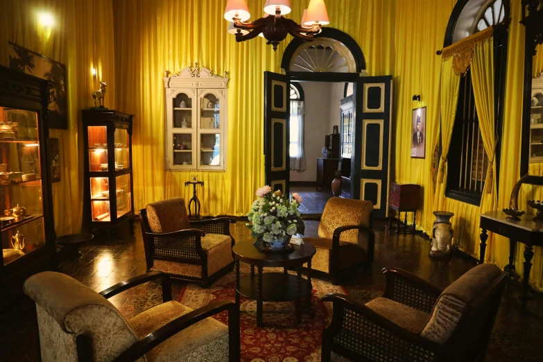 a room with yellow walls and brown chairs