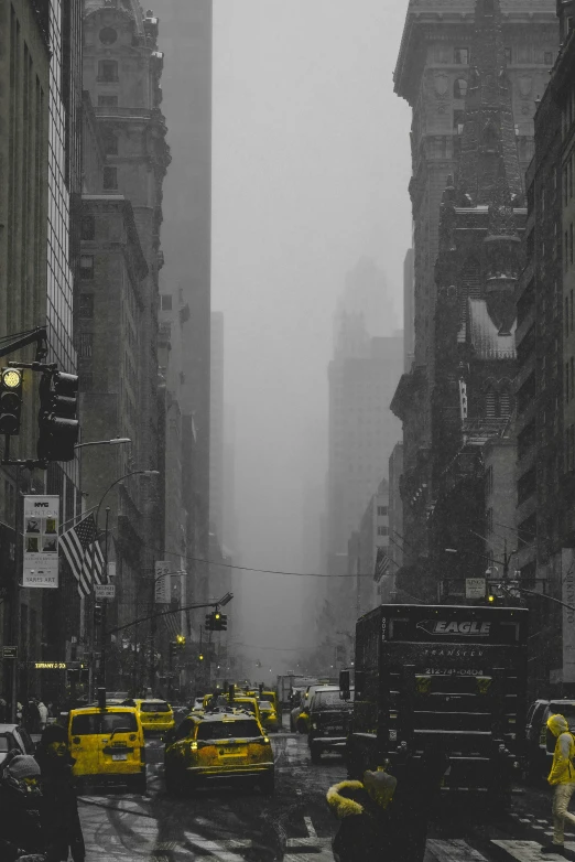 this is an image of city buildings and yellow taxi cabs in the rain