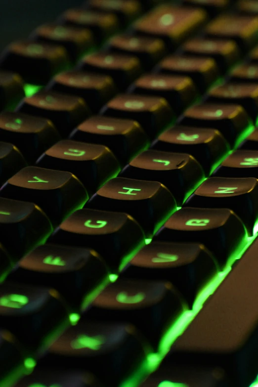 the black keyboard has green glowing keys on it