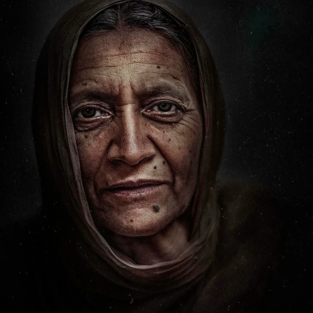 portrait of an elderly woman in a dark and shadowy environment