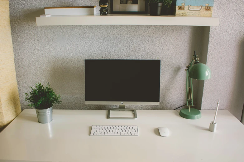 an office with a computer and keyboard on the desk