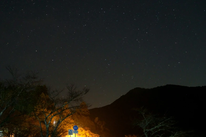 a nighttime view of the mountains with the stars