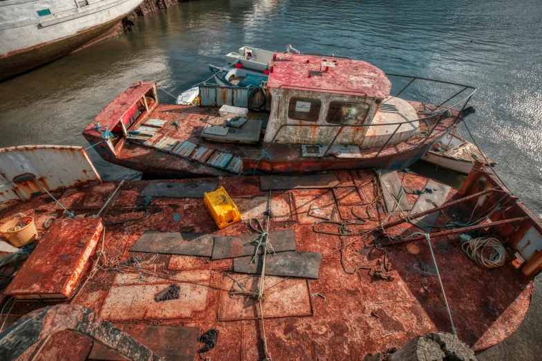 old boats sit on land in the port