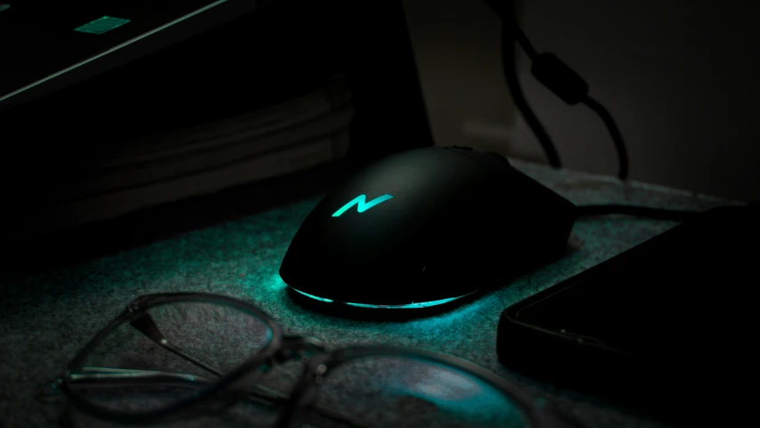 an illuminated computer mouse on top of a table