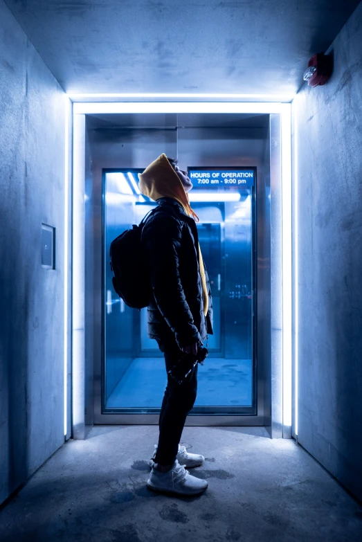 person wearing a backpack standing in a stairwell